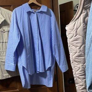 Calvin Klein blue shirt with white stripe.